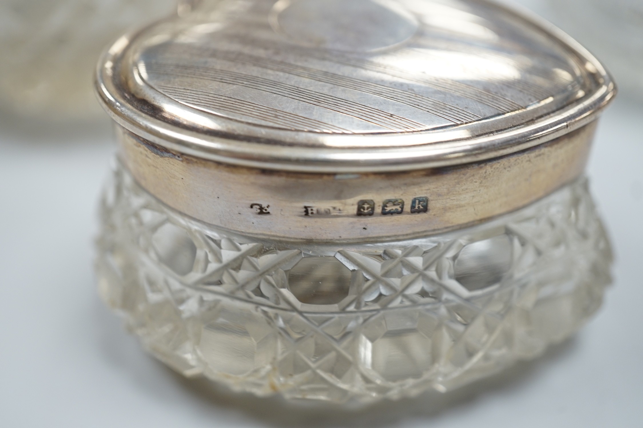 A collection of fourteen assorted late 19th/early 20th century silver mounted cut glass toilet jars or scent bottles, largest 15.5cm, some a.f.